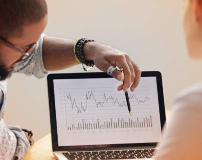 A young black man explaining drug trend data to an Express Scripts Canada client.