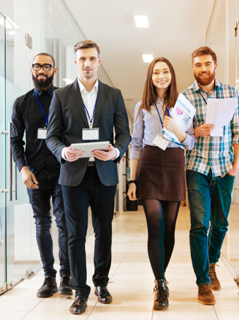 A group of four young Express Scripts Canada health benefit solution developers in an office hallway