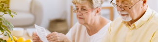 Older Express Scripts Canada members looking at their statement that shows health benefit claims