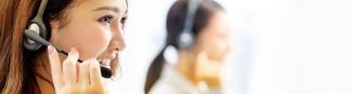 A young Asian female Express Scripts Canada pharmacist assisting a member with questions over the phone