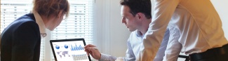 Three people looking at Express Scripts Canada Prescription Drug Trend Reports on a laptop