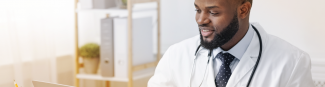 A young black male physician looking up medications